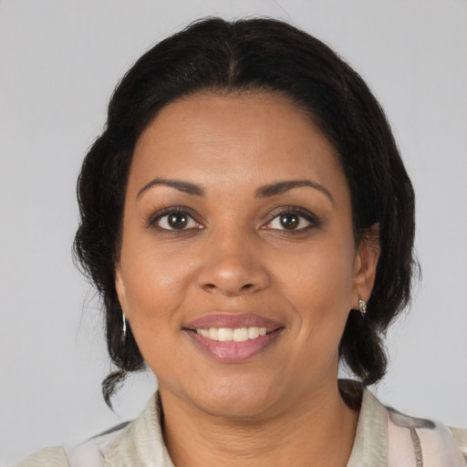 Joyful black young-adult female with medium  brown hair and brown eyes