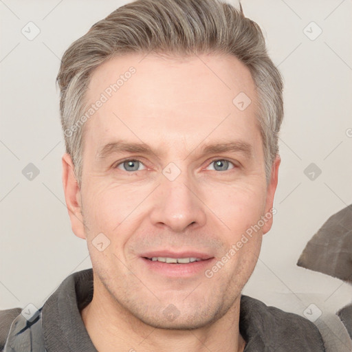 Joyful white adult male with short  brown hair and grey eyes