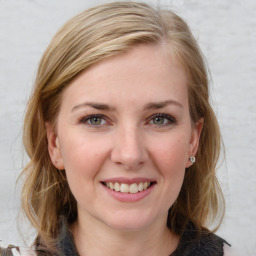 Joyful white young-adult female with medium  brown hair and blue eyes