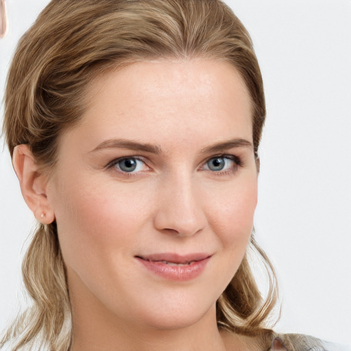 Joyful white young-adult female with medium  brown hair and blue eyes