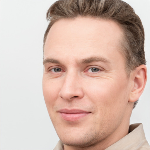 Joyful white adult male with short  brown hair and grey eyes