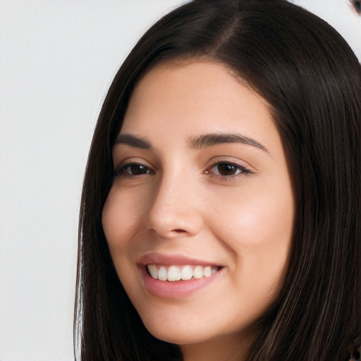 Joyful white young-adult female with long  black hair and brown eyes