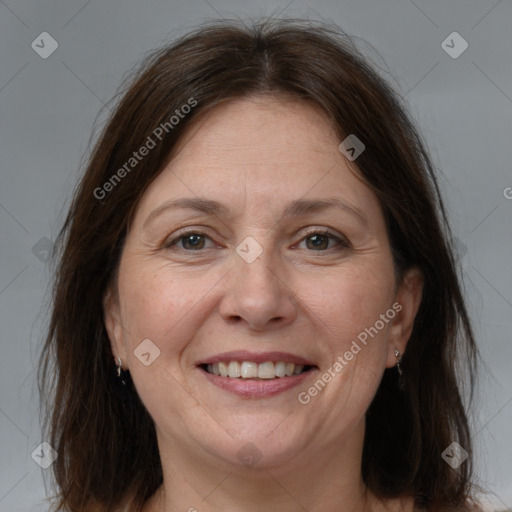 Joyful white adult female with medium  brown hair and brown eyes