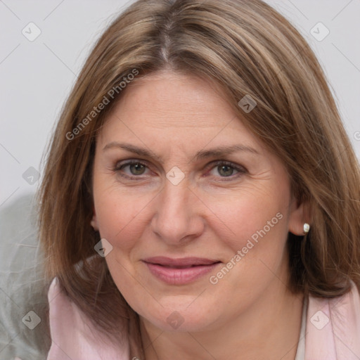 Joyful white adult female with medium  brown hair and grey eyes