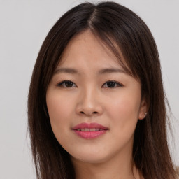 Joyful asian young-adult female with long  brown hair and brown eyes