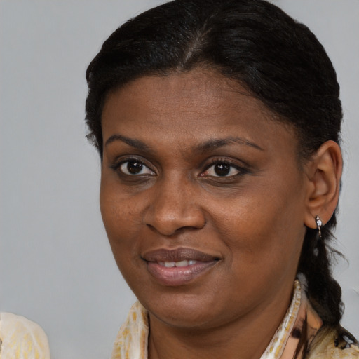 Joyful black young-adult female with medium  brown hair and brown eyes