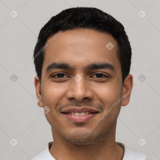 Joyful latino young-adult male with short  black hair and brown eyes