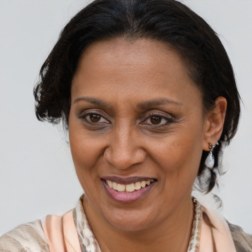 Joyful latino adult female with medium  brown hair and brown eyes
