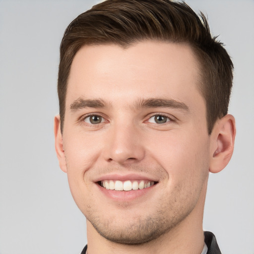 Joyful white young-adult male with short  brown hair and grey eyes