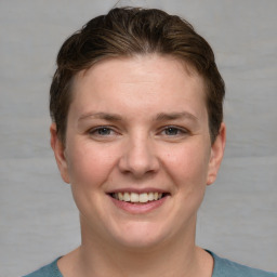 Joyful white young-adult female with short  brown hair and grey eyes