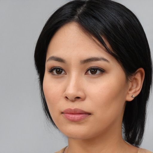 Joyful asian young-adult female with medium  black hair and brown eyes