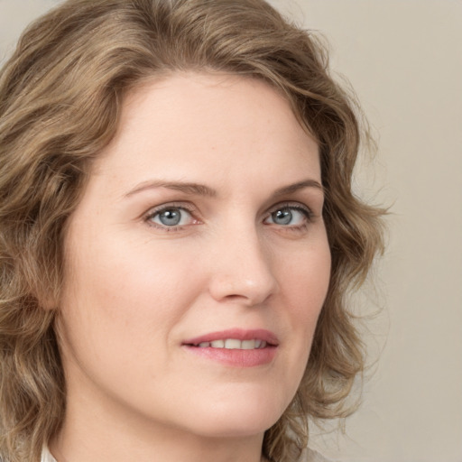 Joyful white young-adult female with medium  brown hair and green eyes