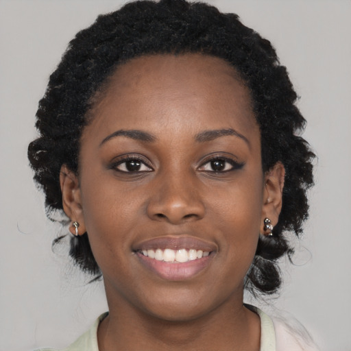 Joyful black young-adult female with medium  black hair and brown eyes