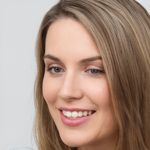 Joyful white young-adult female with long  brown hair and grey eyes