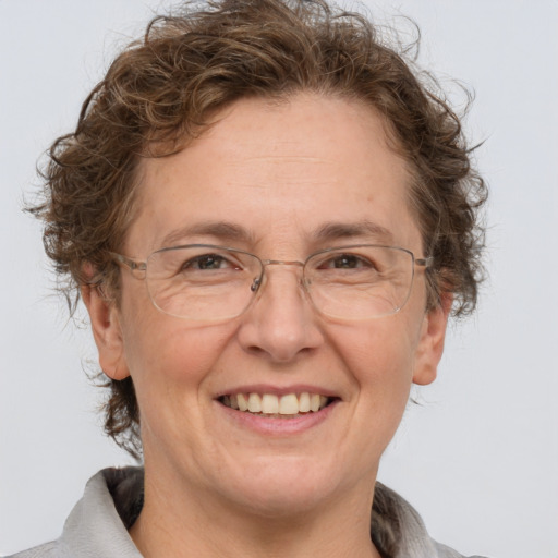 Joyful white middle-aged female with medium  brown hair and grey eyes