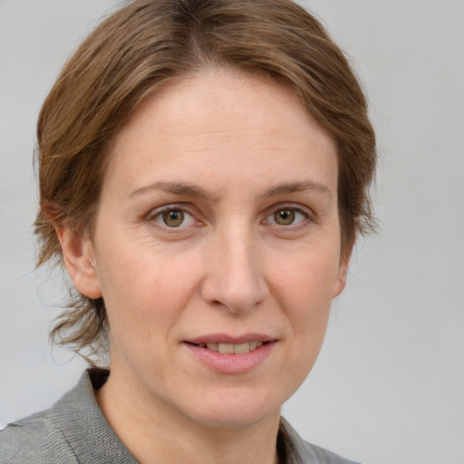 Joyful white adult female with medium  brown hair and grey eyes