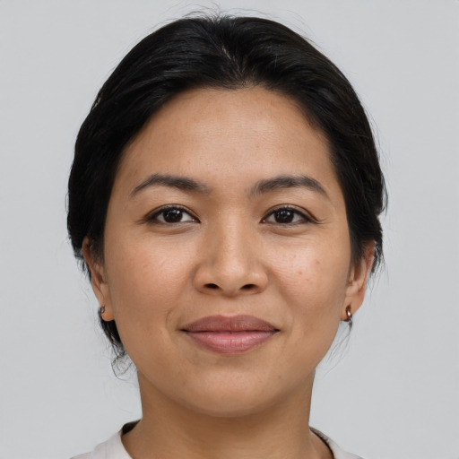 Joyful asian young-adult female with medium  brown hair and brown eyes