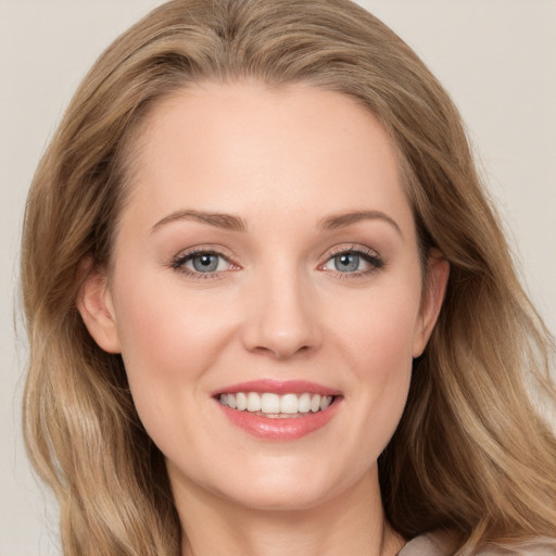 Joyful white young-adult female with long  brown hair and blue eyes