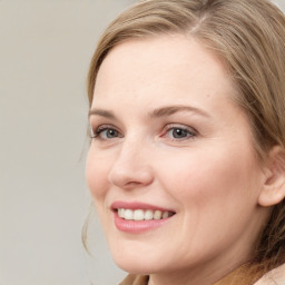 Joyful white young-adult female with medium  brown hair and blue eyes