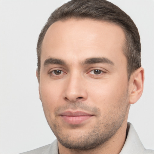 Joyful white young-adult male with short  brown hair and brown eyes