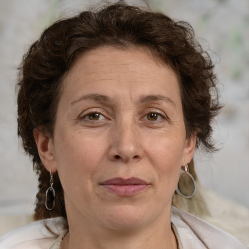 Joyful white adult female with medium  brown hair and green eyes