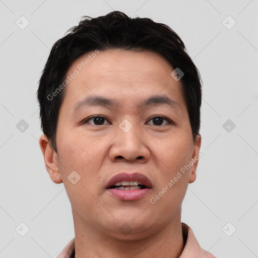 Joyful asian young-adult male with short  black hair and brown eyes