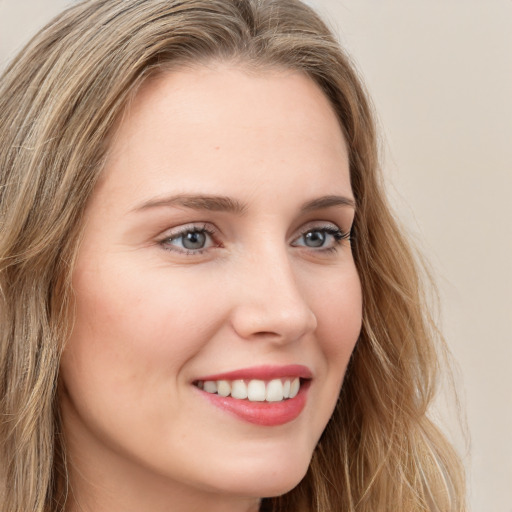 Joyful white young-adult female with long  brown hair and green eyes