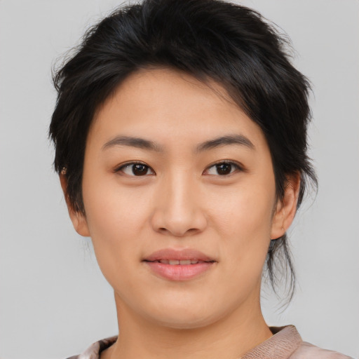 Joyful asian young-adult female with short  brown hair and brown eyes