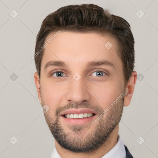 Joyful white young-adult male with short  brown hair and grey eyes