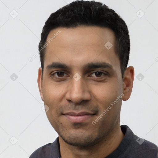 Joyful latino young-adult male with short  black hair and brown eyes