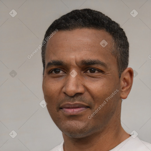 Joyful latino adult male with short  black hair and brown eyes