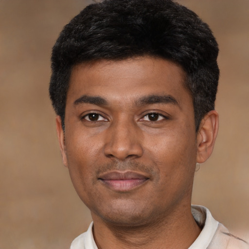 Joyful latino young-adult male with short  black hair and brown eyes
