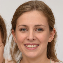 Joyful white young-adult female with medium  brown hair and grey eyes