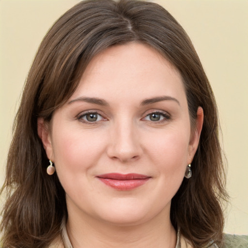 Joyful white young-adult female with long  brown hair and grey eyes