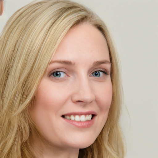 Joyful white young-adult female with long  blond hair and blue eyes