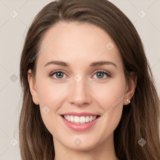 Joyful white young-adult female with long  brown hair and grey eyes