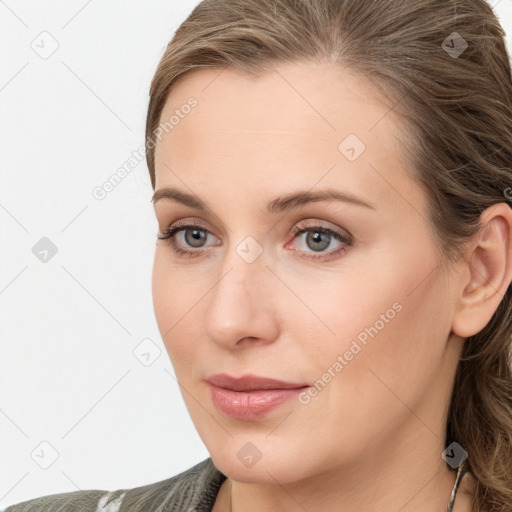 Joyful white young-adult female with medium  brown hair and blue eyes