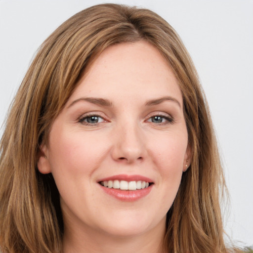 Joyful white young-adult female with long  brown hair and green eyes