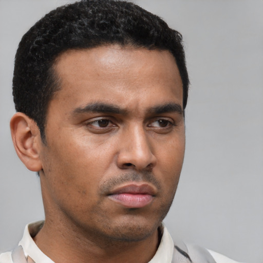 Neutral latino young-adult male with short  black hair and brown eyes