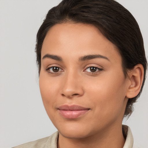 Joyful latino young-adult female with medium  brown hair and brown eyes