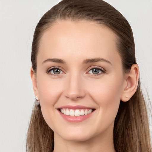 Joyful white young-adult female with long  brown hair and grey eyes