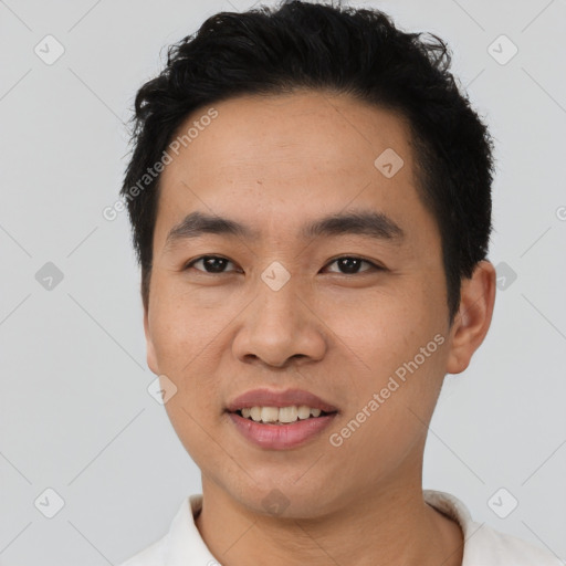 Joyful asian young-adult male with short  black hair and brown eyes