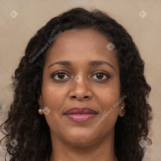 Joyful black young-adult female with long  brown hair and brown eyes