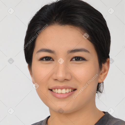 Joyful asian young-adult female with medium  black hair and brown eyes