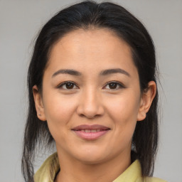 Joyful latino young-adult female with medium  brown hair and brown eyes