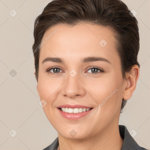 Joyful white young-adult female with short  brown hair and brown eyes