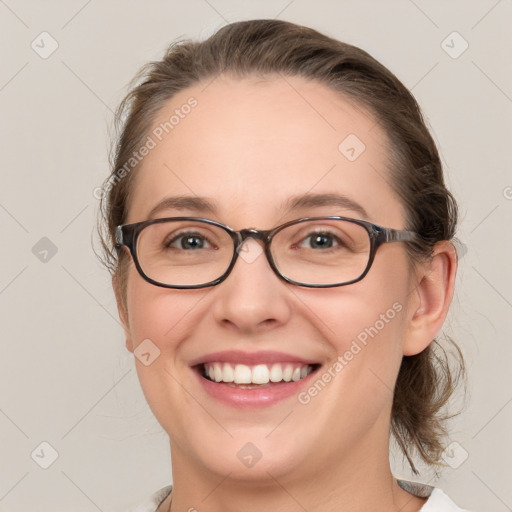 Joyful white young-adult female with medium  brown hair and blue eyes