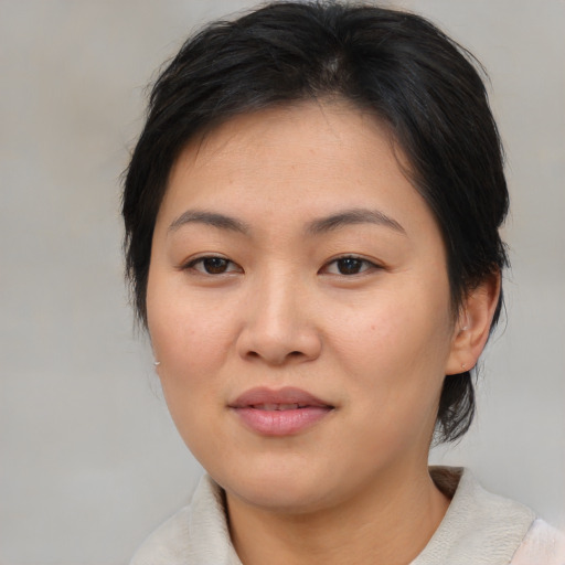 Joyful asian young-adult female with medium  brown hair and brown eyes