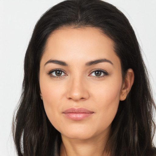 Joyful latino young-adult female with long  brown hair and brown eyes