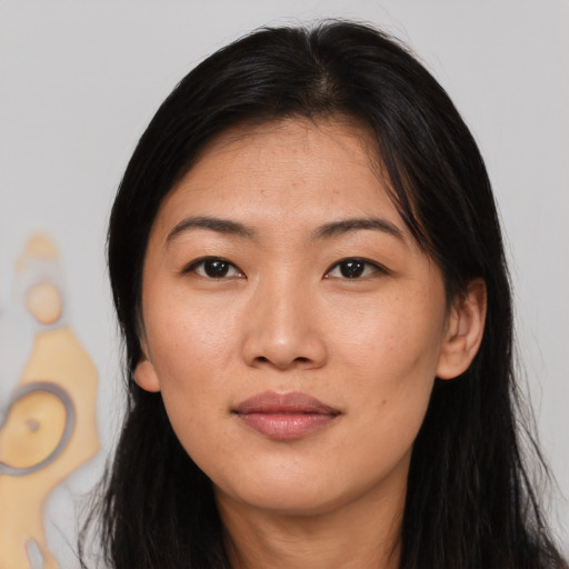 Joyful asian young-adult female with long  black hair and brown eyes